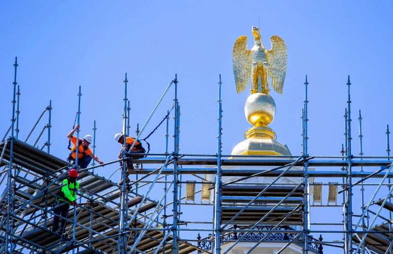 A work crew from Seacoast Scaffolding work on dismantling the scaffolding just below the eagle on Monday, August 22, 2016.